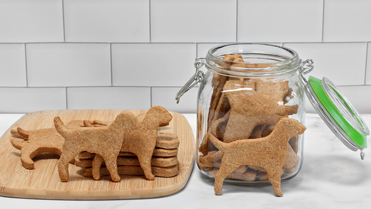 Homemade oat dog biscuits, some in a jar, some on a board