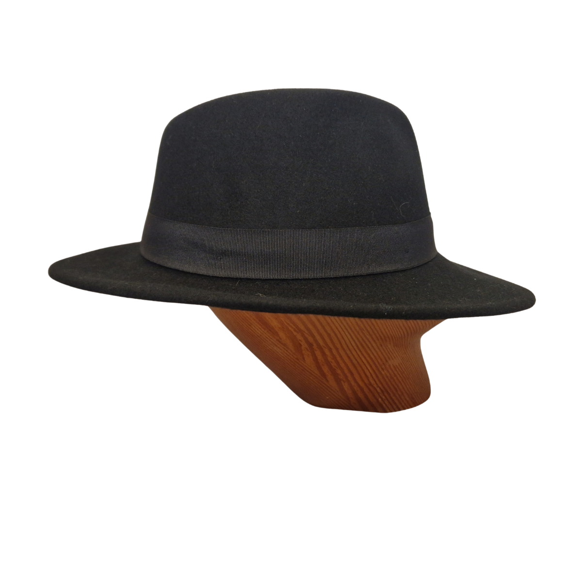 A black felt fedora hat with black ribbon band displayed on a wooden mannequin head against a plain white background. Side