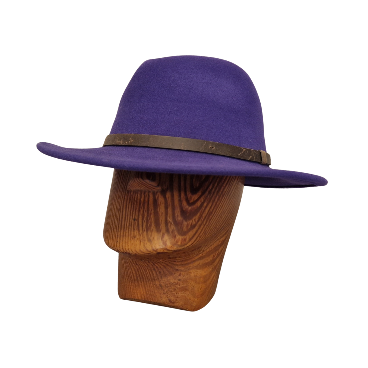 A purple felt fedora hat with a dark brown band, displayed on a wooden mannequin head against a plain white background.
